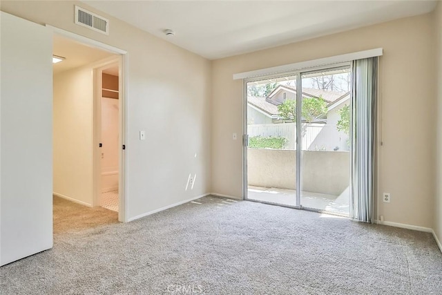 unfurnished room featuring baseboards, visible vents, and carpet flooring