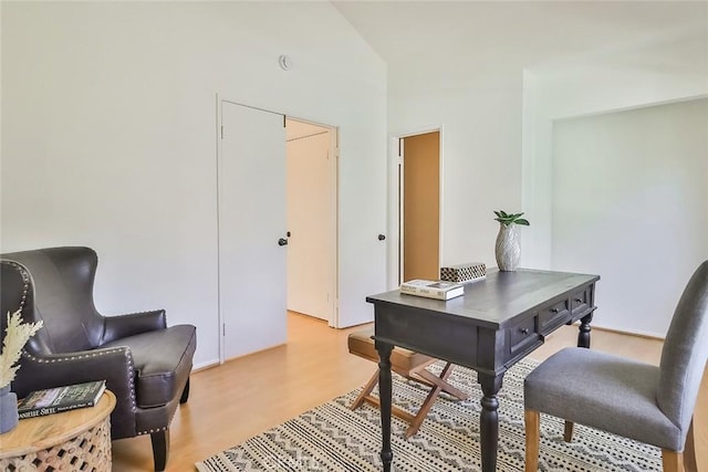 office area with lofted ceiling and light wood-style floors