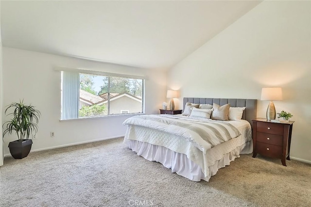 carpeted bedroom with baseboards and vaulted ceiling