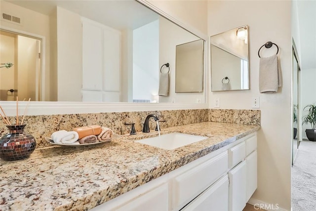 bathroom featuring visible vents and vanity