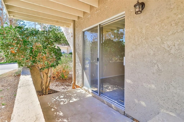 property entrance with stucco siding