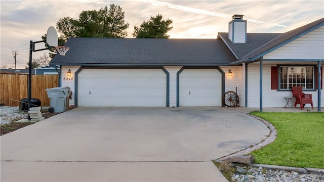 view of home's exterior with a garage, concrete driveway, a chimney, roof with shingles, and fence