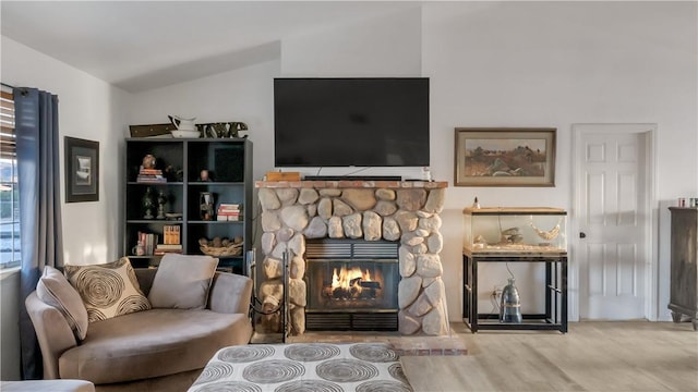 sitting room featuring vaulted ceiling, a fireplace, and wood finished floors