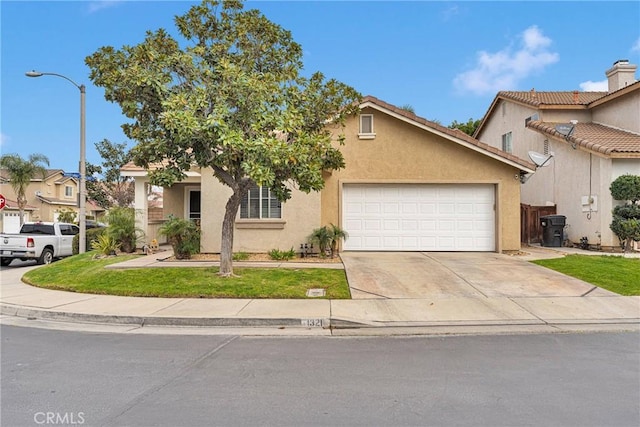 view of front facade featuring driveway, an attached garage, a front lawn, and stucco siding