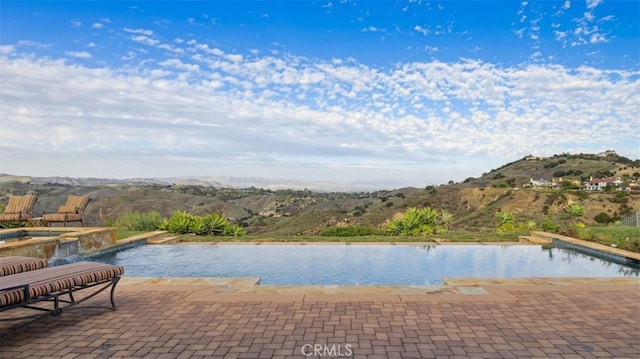 view of pool with a mountain view