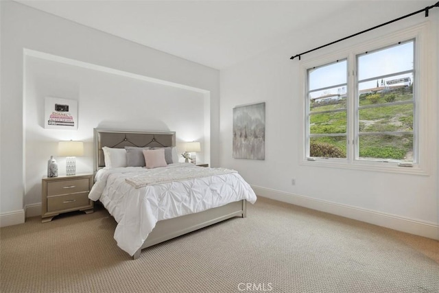 carpeted bedroom with baseboards