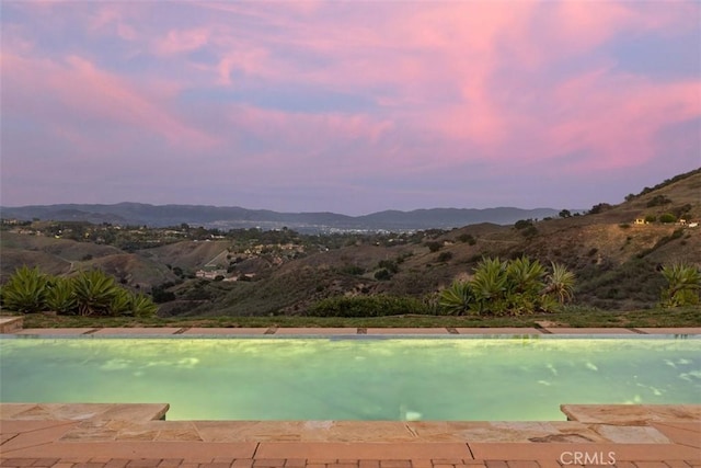 view of swimming pool featuring a mountain view