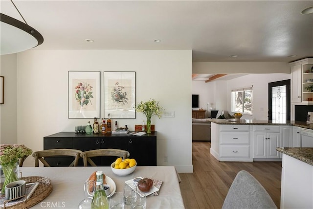 dining space with light wood-style floors and recessed lighting