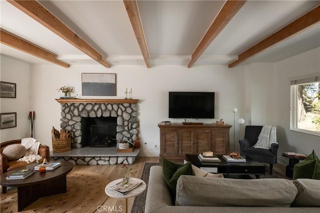 living area featuring a fireplace, wood finished floors, and beamed ceiling