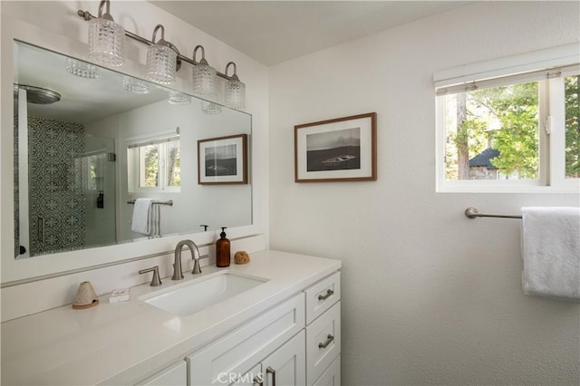 full bath with a stall shower and vanity