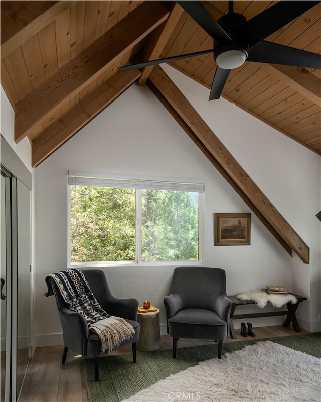 sitting room featuring a ceiling fan, wooden ceiling, vaulted ceiling with beams, and wood finished floors