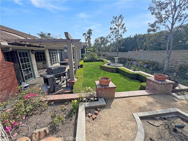 view of yard with a fenced backyard, a patio, and a fire pit