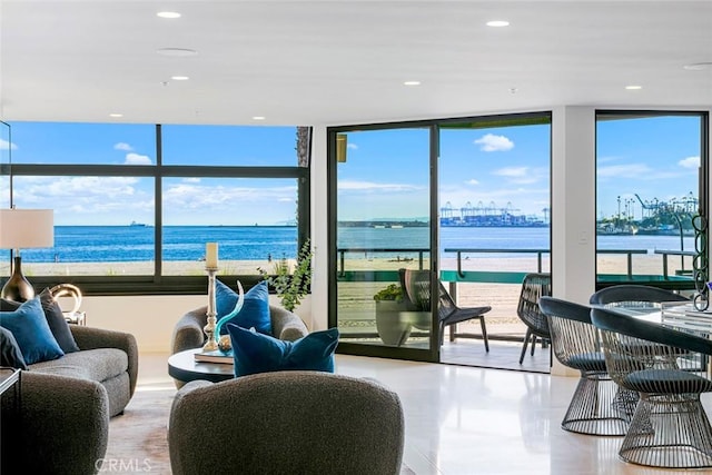 interior space featuring expansive windows, a water view, and recessed lighting