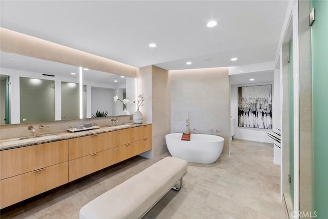 1310 E Ocean Blvd Unit 14, Long Beach, CA 90802 - bathroom featuring double vanity, a freestanding tub, and recessed lighting
