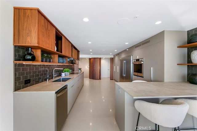 kitchen featuring stainless steel appliances, backsplash, a sink, and open shelves