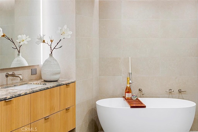 1310 E Ocean Blvd Unit 14, Long Beach, CA 90802 - bathroom with tile walls, vanity, a soaking tub, and decorative backsplash