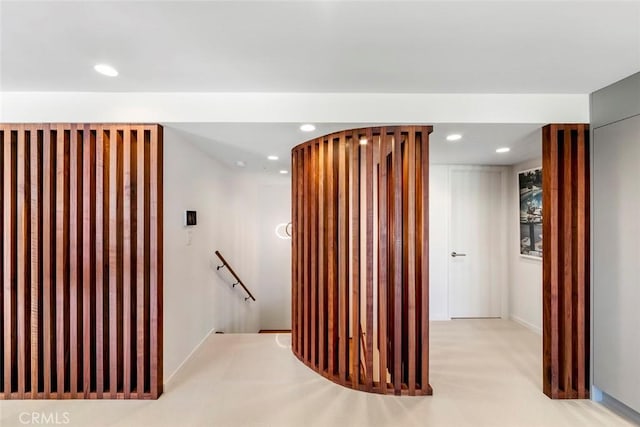 corridor with an upstairs landing and recessed lighting