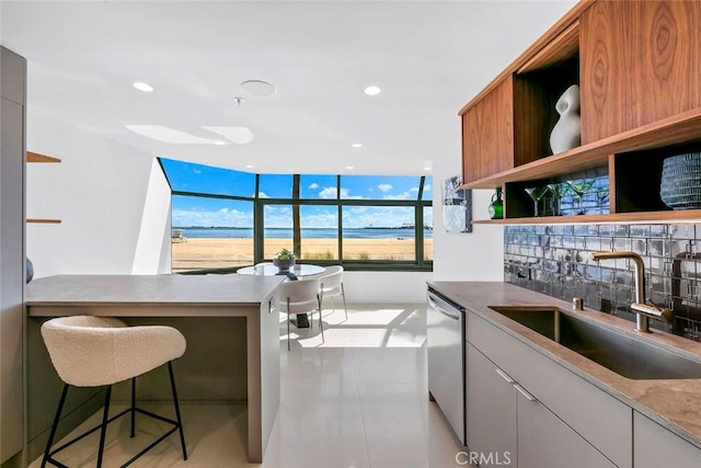 kitchen with backsplash, a sink, open shelves, stainless steel dishwasher, and recessed lighting