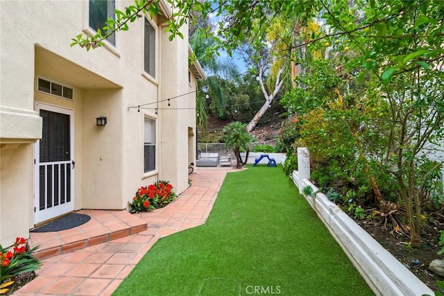 view of yard with a patio and fence