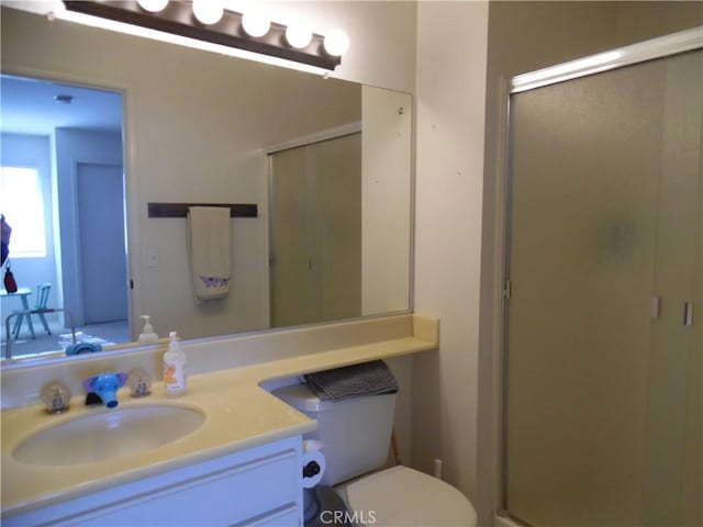 full bathroom with a stall shower, vanity, and toilet