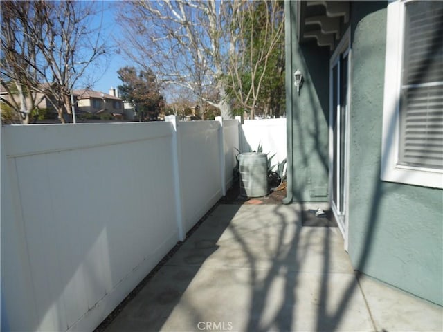 exterior space with a patio, fence, and stucco siding