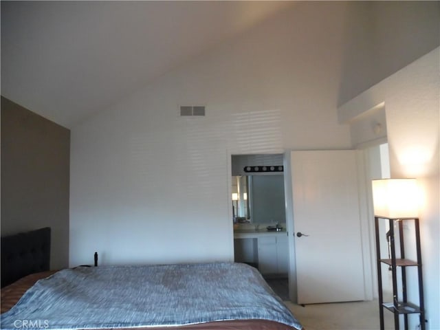 bedroom featuring high vaulted ceiling and visible vents