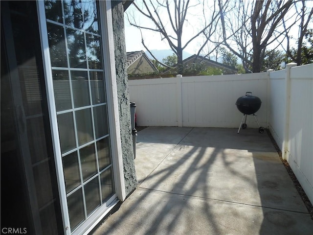 view of patio / terrace with area for grilling and fence