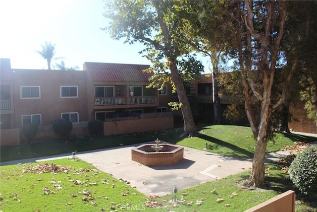 view of community with a lawn and a fire pit