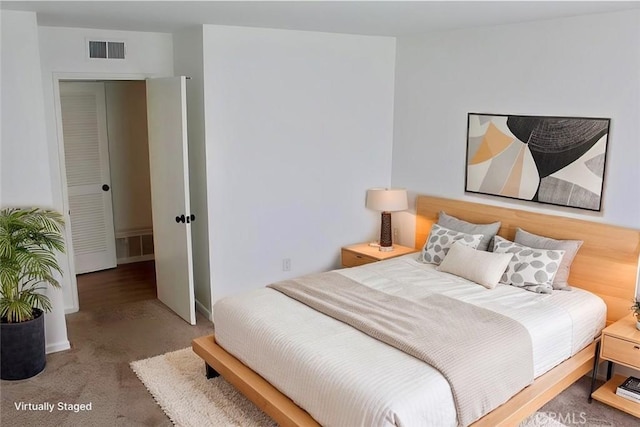 carpeted bedroom featuring visible vents