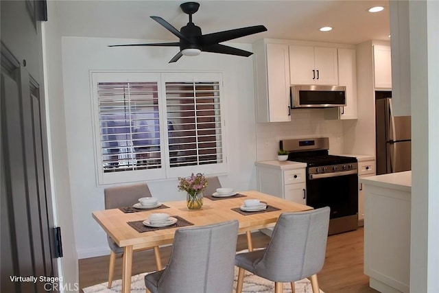 dining space featuring light wood-type flooring, a ceiling fan, and recessed lighting