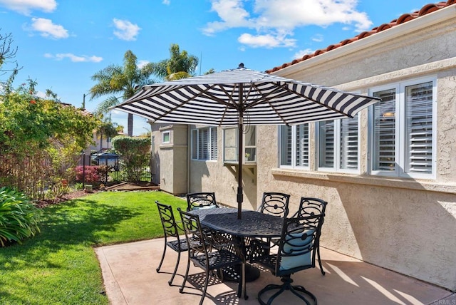 view of patio with fence and outdoor dining space