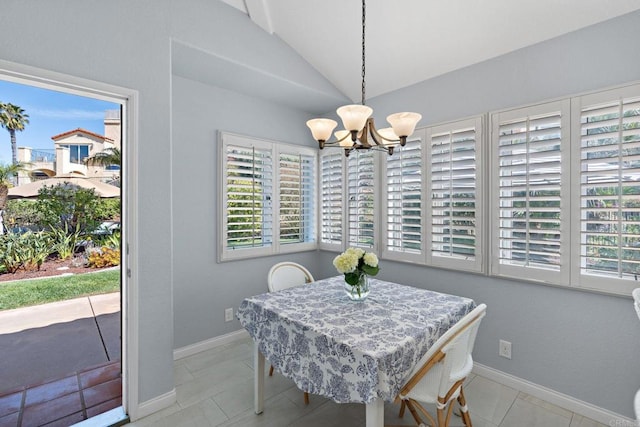 dining area featuring lofted ceiling, baseboards, a notable chandelier, and a healthy amount of sunlight