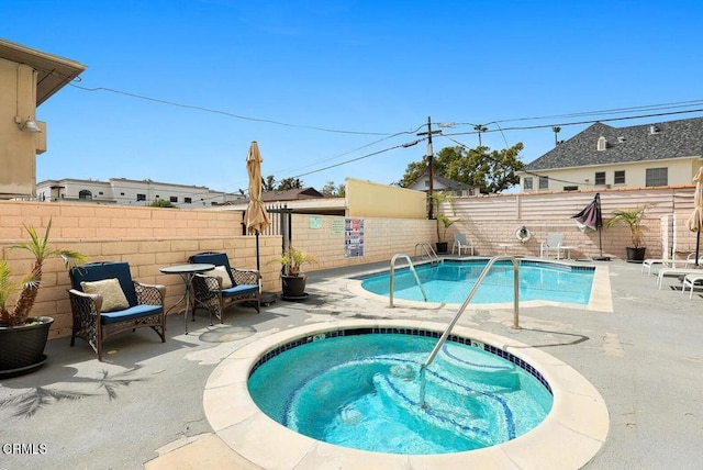 view of swimming pool featuring a fenced in pool, a patio area, a fenced backyard, and an in ground hot tub