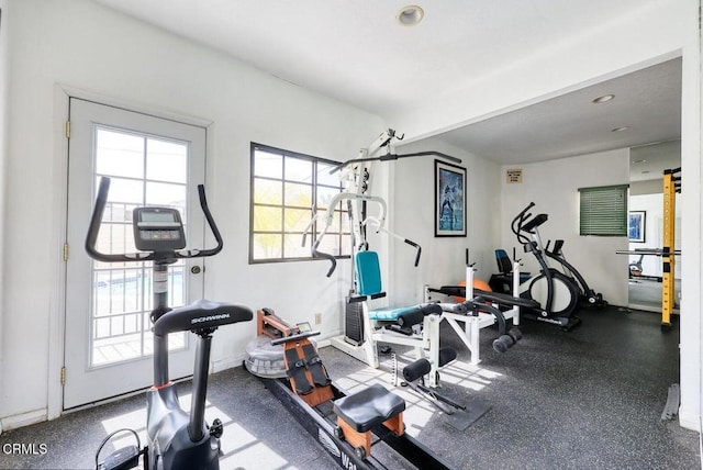 workout room featuring baseboards