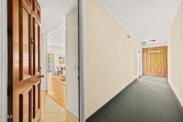 hall featuring light tile patterned flooring