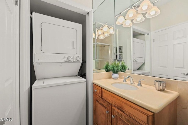 bathroom with stacked washer / dryer and vanity