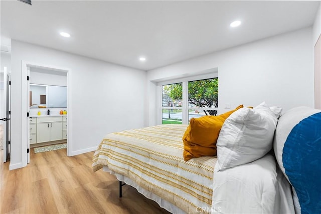 bedroom featuring light wood-style floors, recessed lighting, ensuite bath, and baseboards