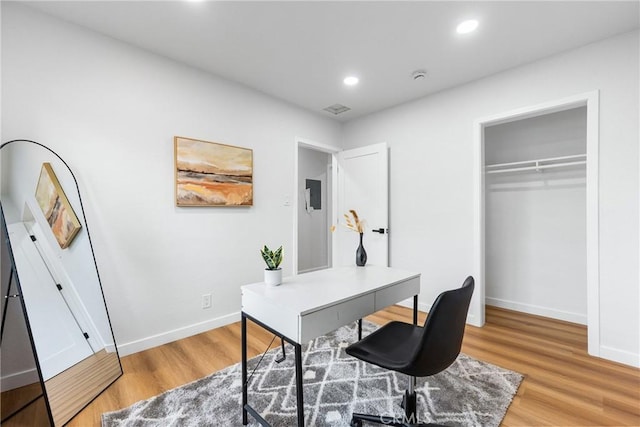 office featuring recessed lighting, light wood-style flooring, and baseboards