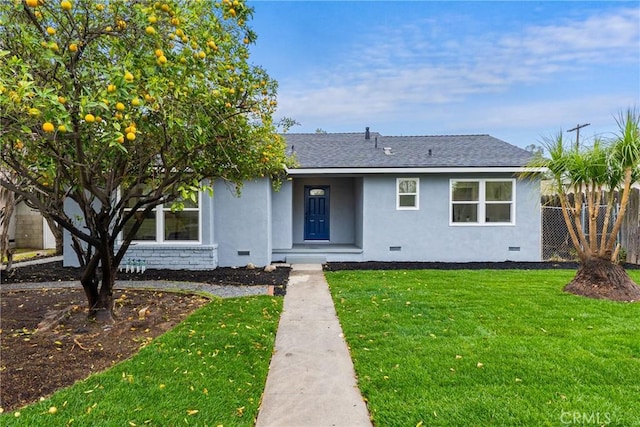 view of front facade with a shingled roof, crawl space, fence, a front yard, and stucco siding