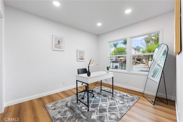 office featuring light wood-type flooring, baseboards, and recessed lighting