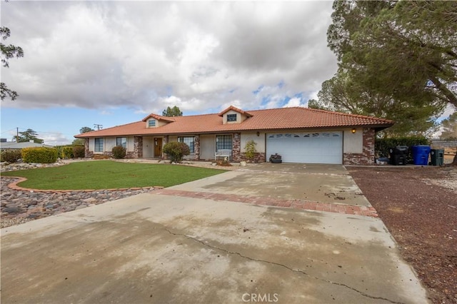 ranch-style home featuring a garage, a tile roof, concrete driveway, stucco siding, and a front yard