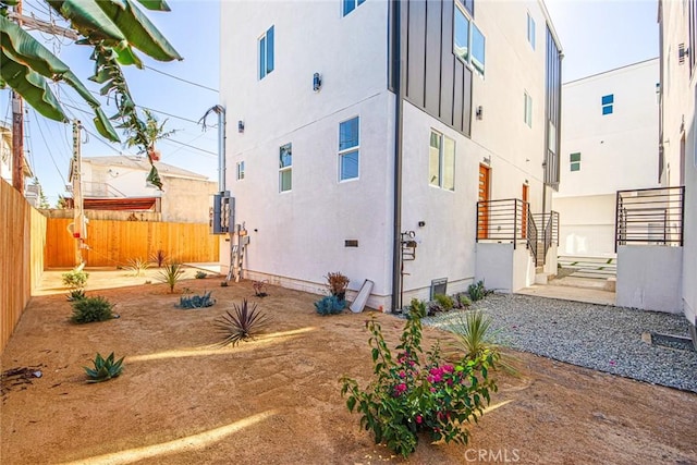 exterior space featuring fence and stucco siding