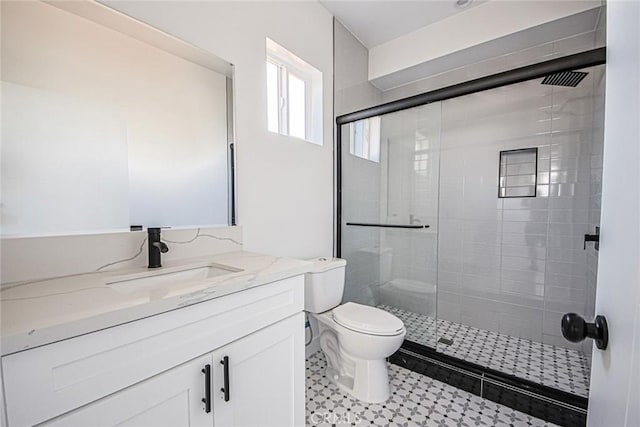 full bath featuring toilet, a stall shower, and vanity