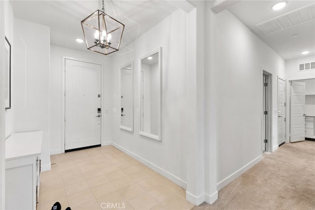 entrance foyer featuring recessed lighting, visible vents, baseboards, and an inviting chandelier