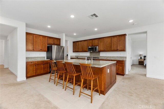 kitchen featuring light carpet, appliances with stainless steel finishes, visible vents, and recessed lighting