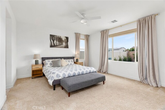 bedroom with carpet floors, visible vents, baseboards, and a ceiling fan