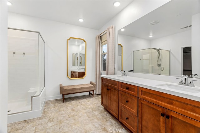 bathroom featuring double vanity, a sink, visible vents, and a shower stall