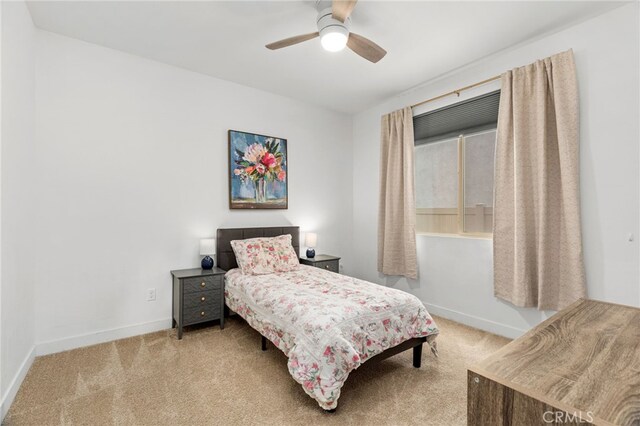 bedroom with ceiling fan, carpet floors, and baseboards