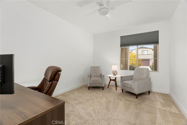 carpeted office featuring a ceiling fan and baseboards