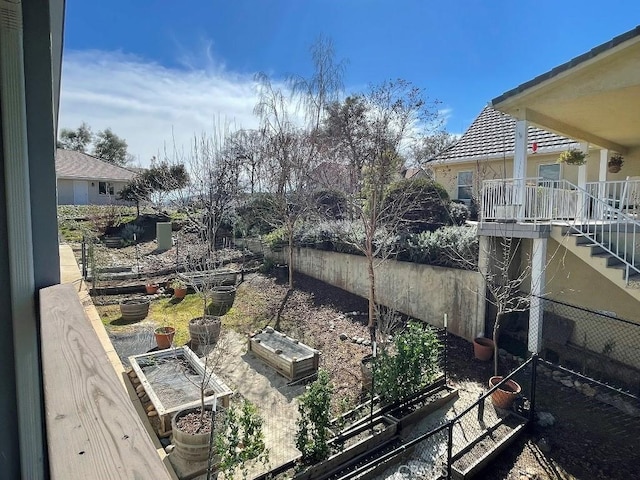 view of yard with fence and a garden